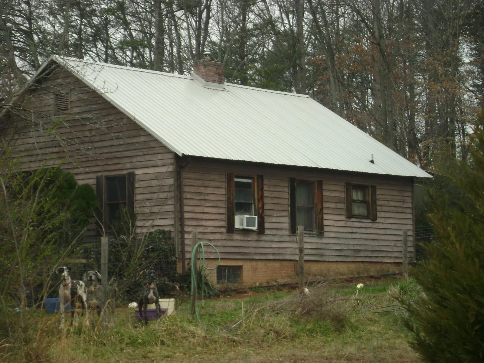 White metal roof on an old wood sided farmhouse, from a Metal Roof Installation job in Chauncey